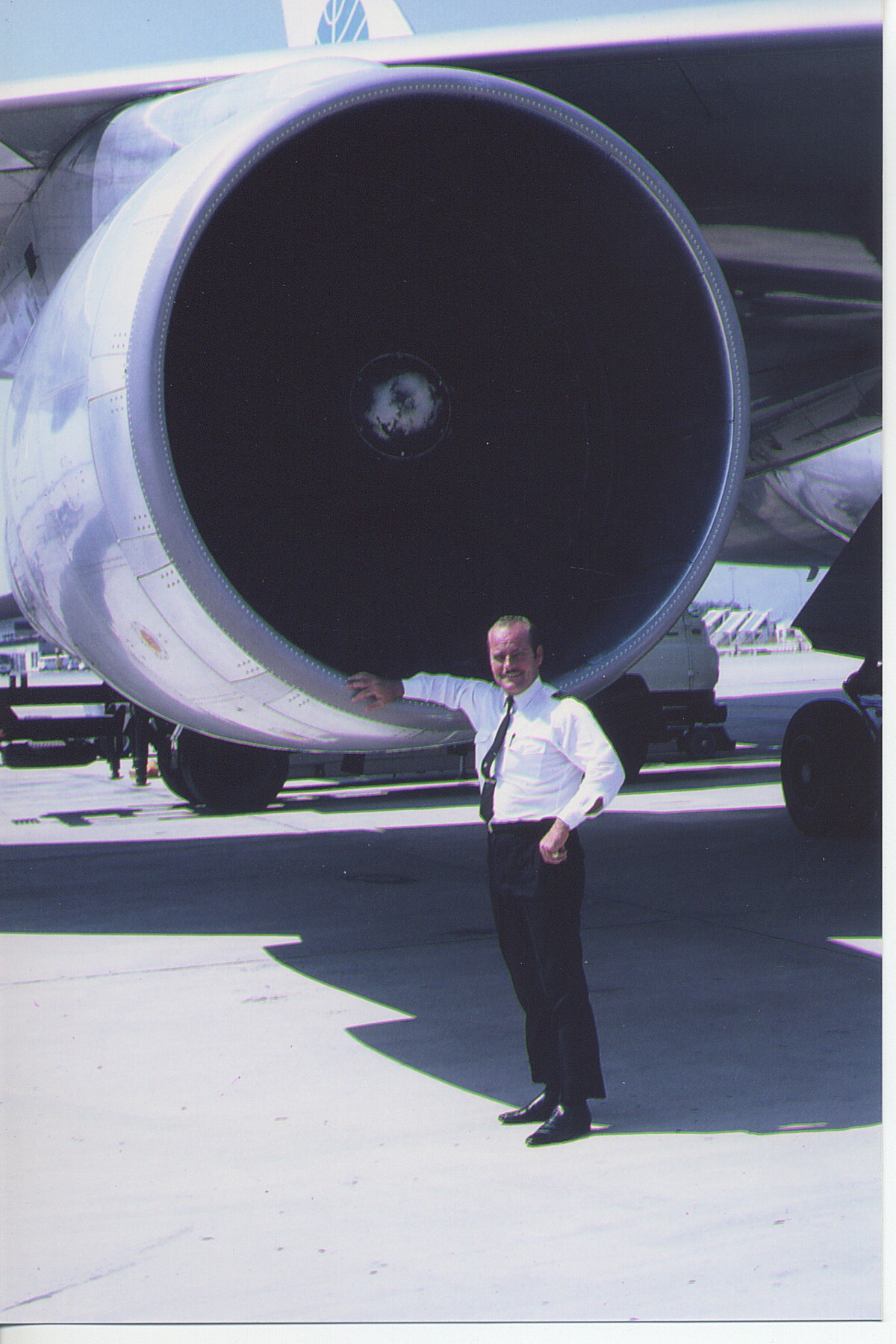 1970 Ray LeDour posing by the massive engine of a Pan Am Boeing 747.