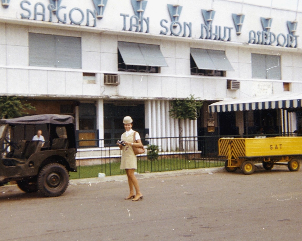 1970 Pan Am Flight Attendant, Marueen van Leeuwen at the ramp side entrance toe the passenger terminal at Ton Son Nhut Airport in Saigon Vietnam.